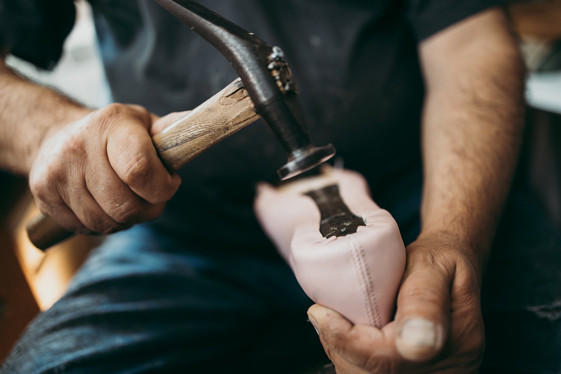 Close up shot of old shoemaker in his store. Traditional way of shoe making process., Close up shot of old shoemaker in his store. Traditional way of