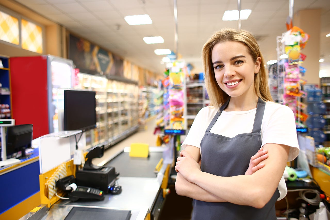 Portrait of female cashier in supermarket