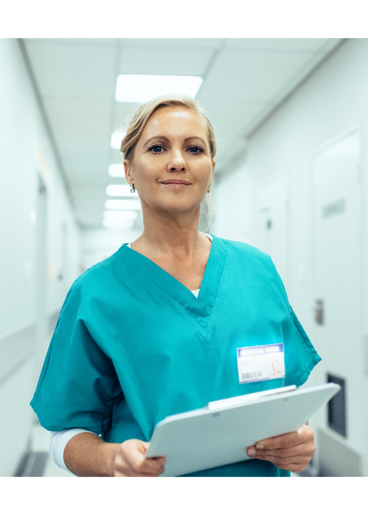 Portrait of mature female nurse working in hospital. Woman healthcare worker with clipboard in corridor.